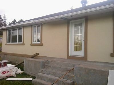 Front entry after completion, cream acrylic finish with brown surrounds.