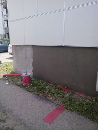 Smooth grey coating being applied to the foundation.